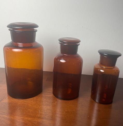 Three Vintage Amber Glass Apothecary Jars With Glass Stoppers