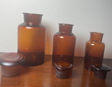 Three Vintage Amber Glass Apothecary Jars With Glass Stoppers
